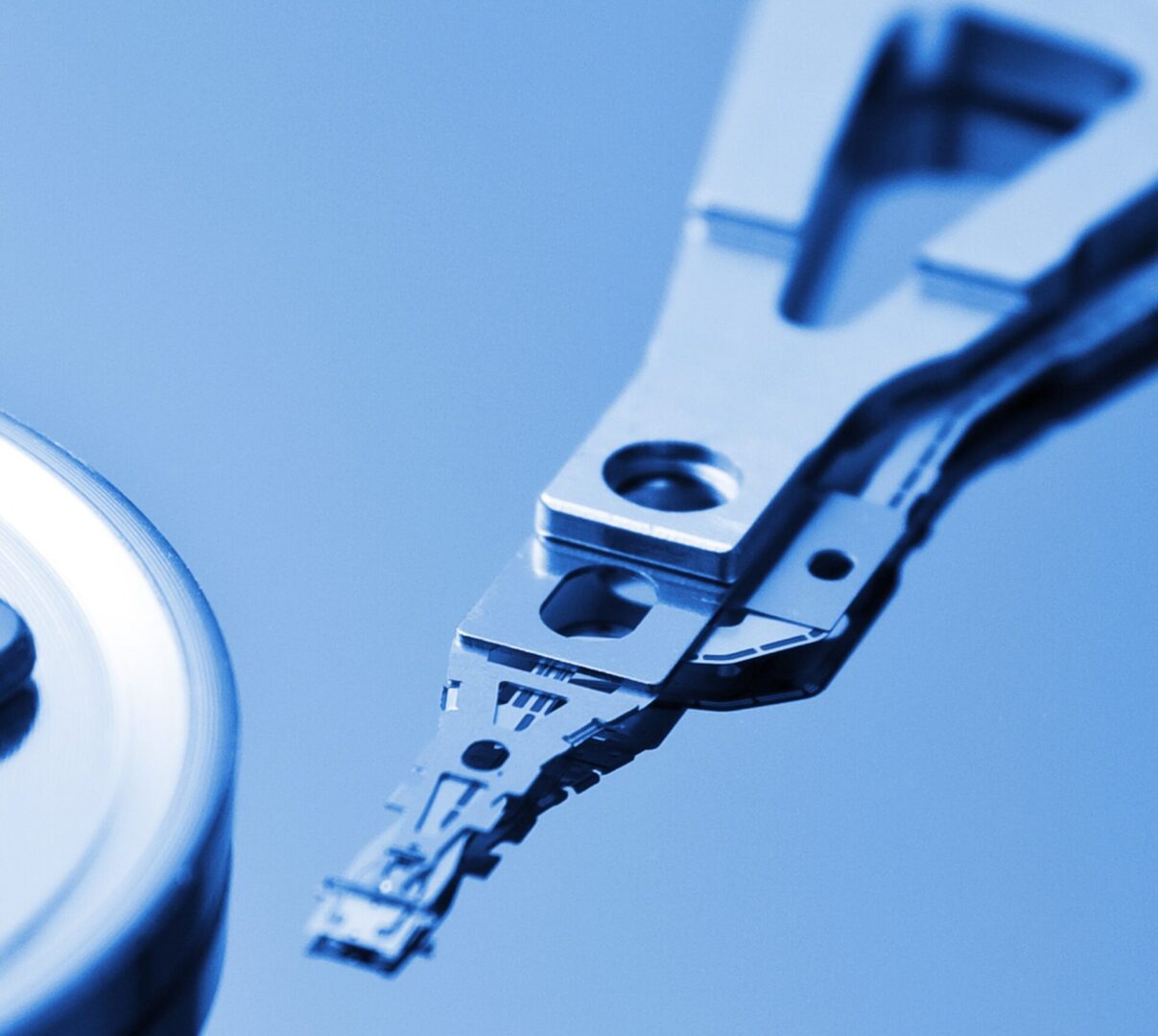 Hard drive components close-up in blue tone.